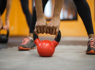 Close up on a person's hands gripping a kettlebell.